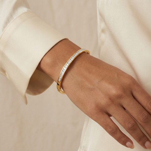 Beam bangle worn with youthful adult-hand styling