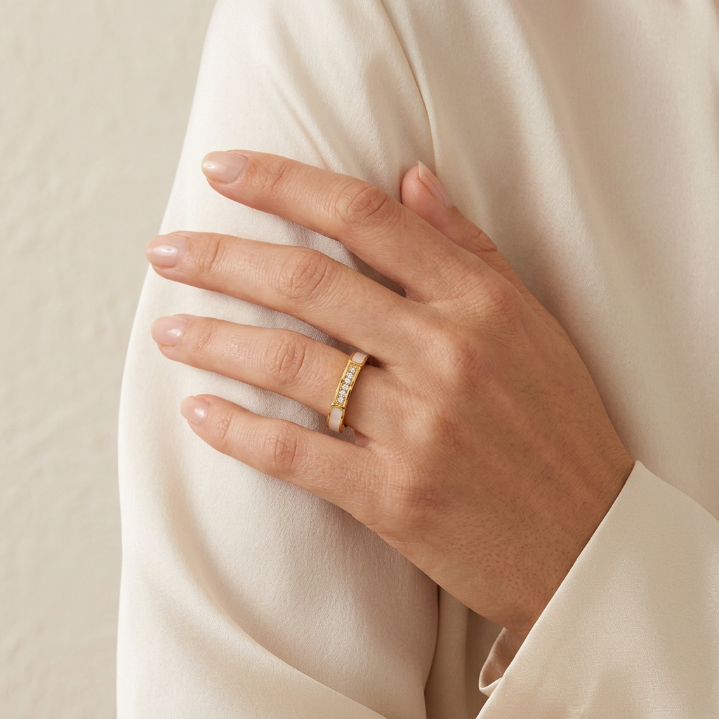 Ivory gold-plated ring worn on a hand